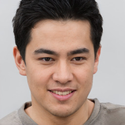 Joyful asian young-adult male with short  brown hair and brown eyes