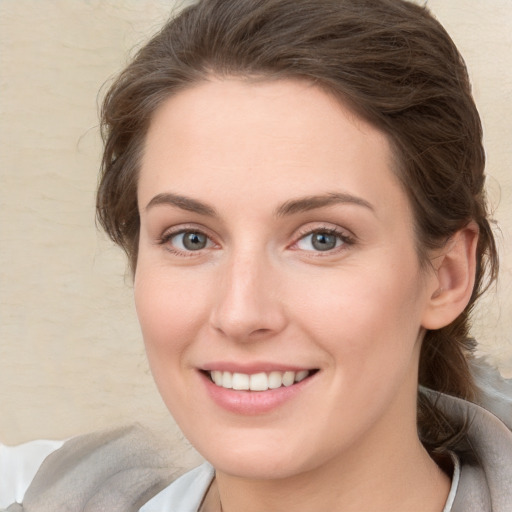 Joyful white young-adult female with medium  brown hair and blue eyes