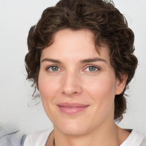 Joyful white young-adult female with medium  brown hair and green eyes