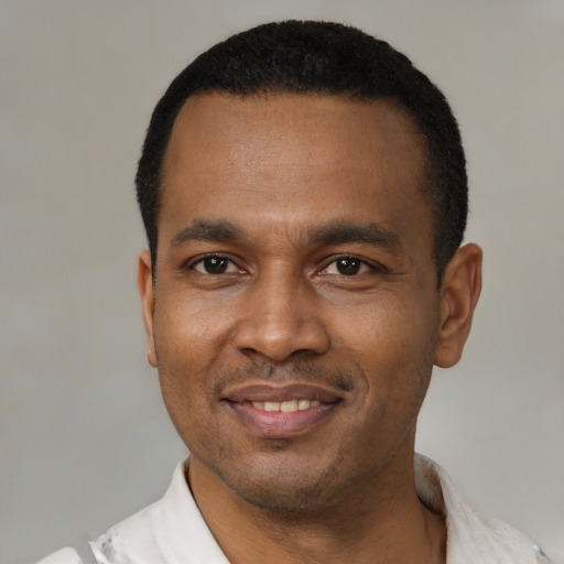 Joyful latino adult male with short  black hair and brown eyes