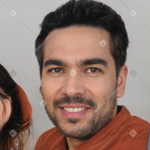 Joyful white young-adult male with short  black hair and brown eyes