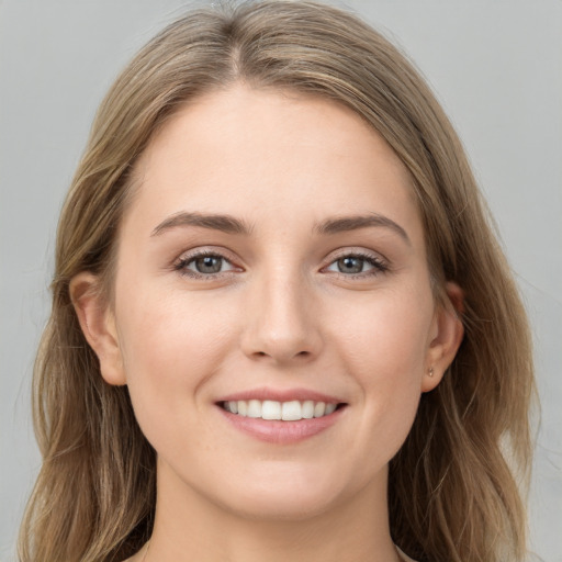 Joyful white young-adult female with long  brown hair and grey eyes