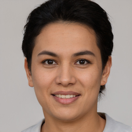 Joyful latino young-adult female with short  brown hair and brown eyes