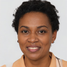 Joyful black adult female with short  brown hair and brown eyes