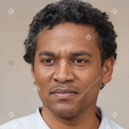 Neutral latino adult male with short  black hair and brown eyes