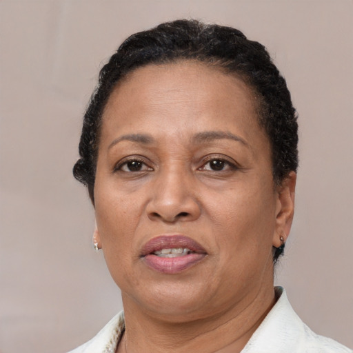 Joyful latino adult female with short  brown hair and brown eyes