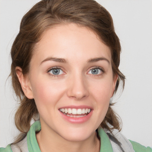 Joyful white young-adult female with medium  brown hair and blue eyes