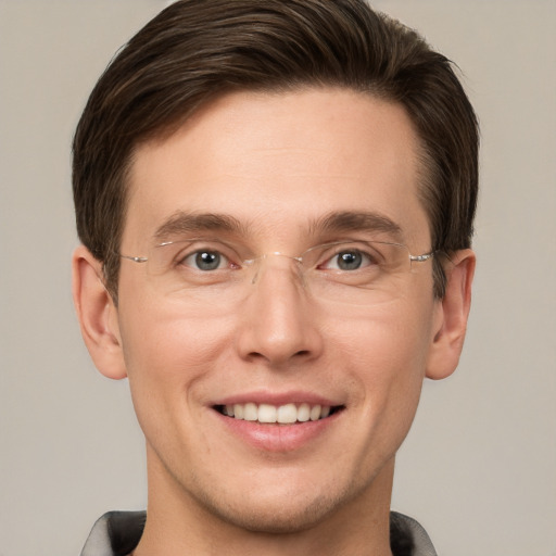 Joyful white adult male with short  brown hair and grey eyes