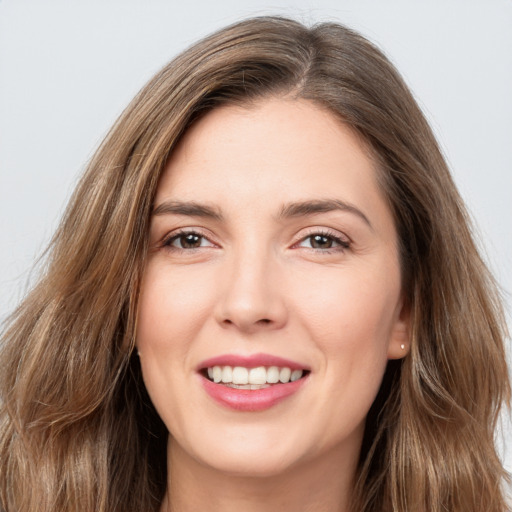 Joyful white young-adult female with long  brown hair and grey eyes