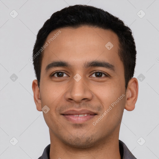 Joyful latino young-adult male with short  black hair and brown eyes
