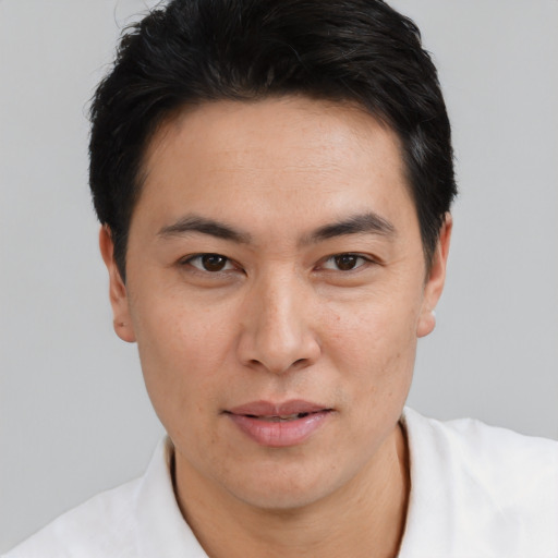 Joyful asian young-adult male with short  black hair and brown eyes