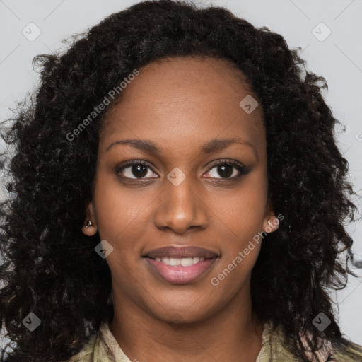 Joyful black young-adult female with long  brown hair and brown eyes