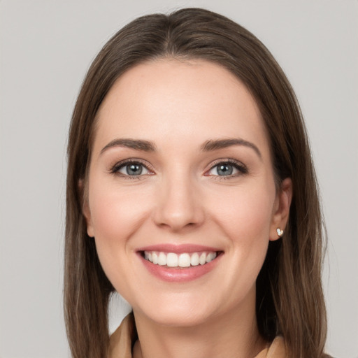 Joyful white young-adult female with long  brown hair and grey eyes