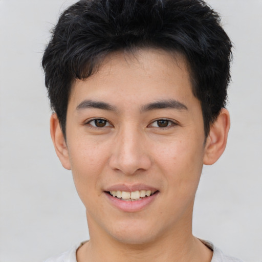 Joyful asian young-adult male with short  brown hair and brown eyes