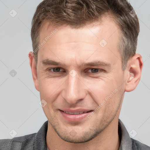 Joyful white adult male with short  brown hair and brown eyes