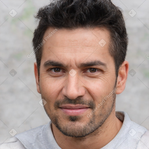 Joyful white adult male with short  black hair and brown eyes