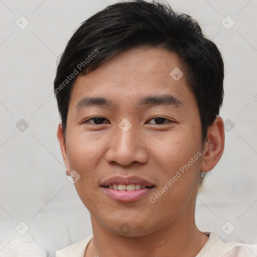 Joyful asian young-adult male with short  brown hair and brown eyes