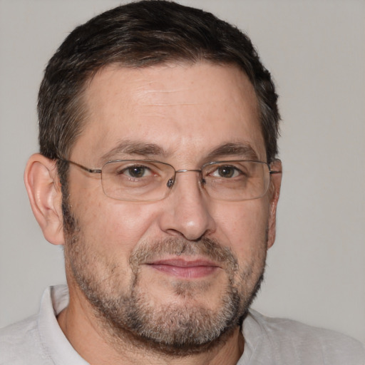 Joyful white adult male with short  brown hair and brown eyes