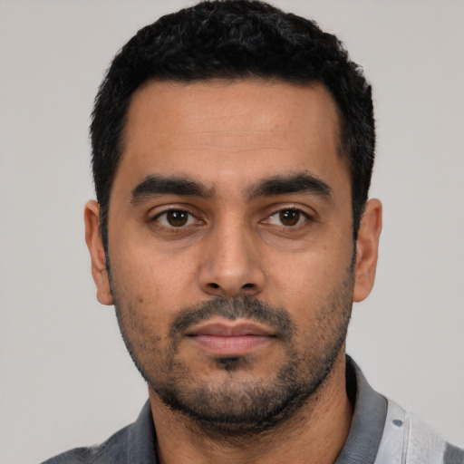 Neutral latino young-adult male with short  black hair and brown eyes