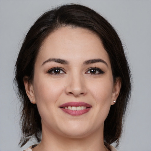 Joyful white young-adult female with medium  brown hair and brown eyes