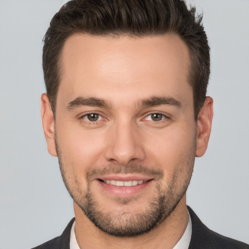 Joyful white young-adult male with short  brown hair and brown eyes