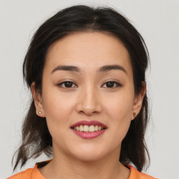 Joyful asian young-adult female with medium  brown hair and brown eyes