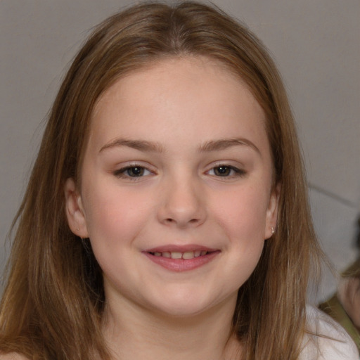 Joyful white child female with long  brown hair and brown eyes