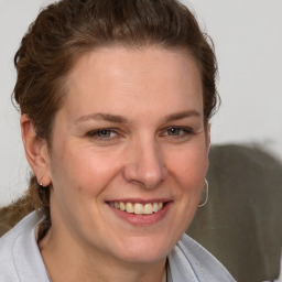 Joyful white adult female with short  brown hair and brown eyes