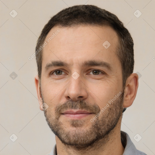 Joyful white adult male with short  brown hair and brown eyes