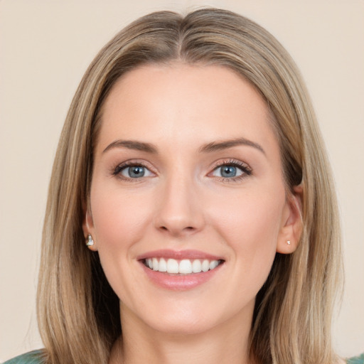 Joyful white young-adult female with long  brown hair and green eyes