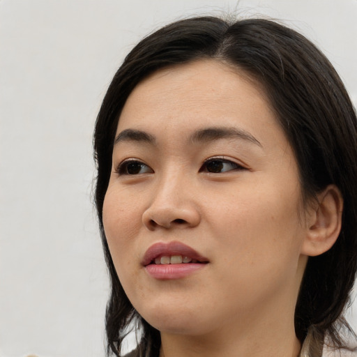 Joyful asian young-adult female with medium  brown hair and brown eyes