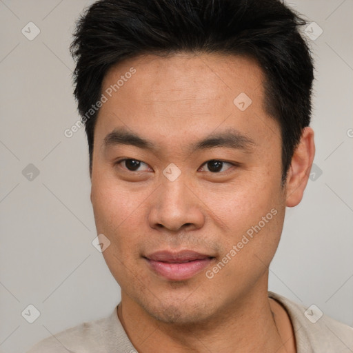 Joyful asian young-adult male with short  black hair and brown eyes