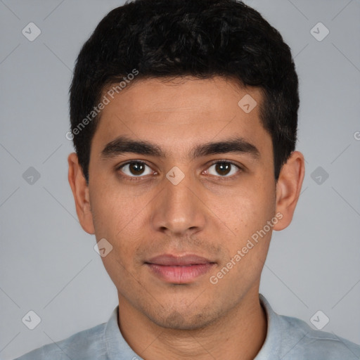 Joyful white young-adult male with short  black hair and brown eyes