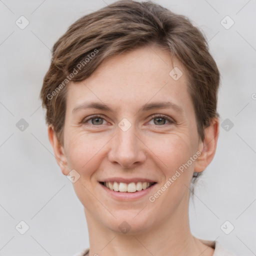 Joyful white young-adult female with short  brown hair and grey eyes