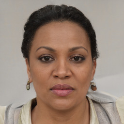 Joyful latino adult female with short  brown hair and brown eyes