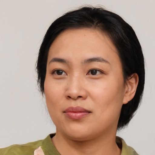 Joyful white young-adult female with medium  black hair and brown eyes