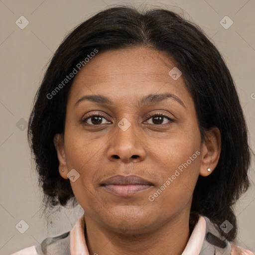 Joyful latino adult female with medium  brown hair and brown eyes