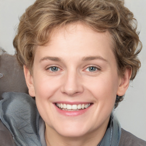 Joyful white young-adult female with medium  brown hair and blue eyes