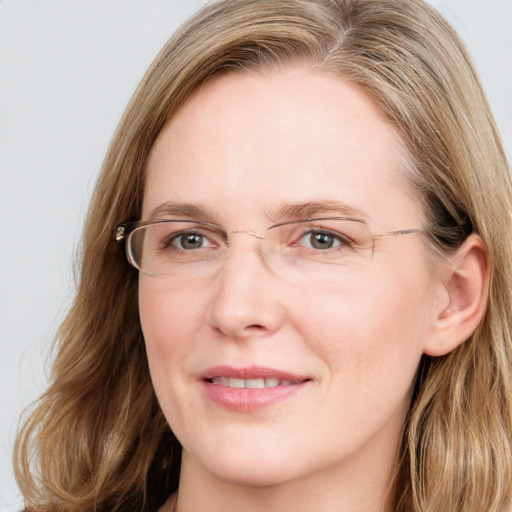 Joyful white adult female with long  brown hair and blue eyes