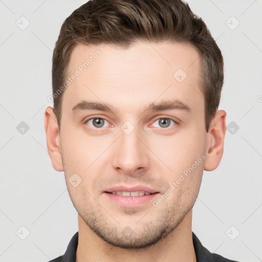 Joyful white young-adult male with short  brown hair and grey eyes