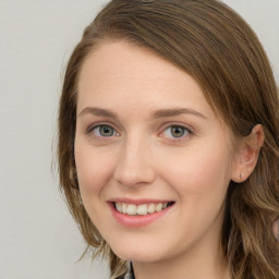 Joyful white young-adult female with long  brown hair and green eyes