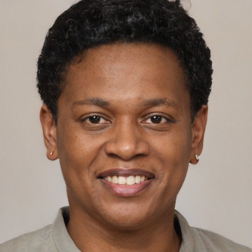 Joyful latino adult male with short  brown hair and brown eyes