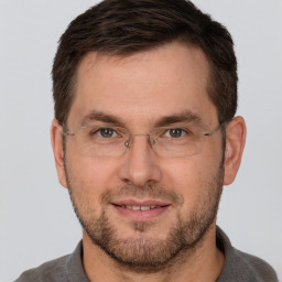 Joyful white adult male with short  brown hair and brown eyes