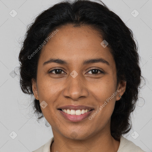 Joyful black adult female with medium  brown hair and brown eyes