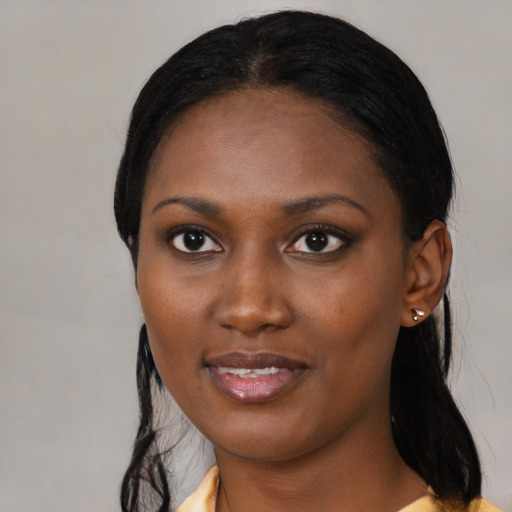 Joyful black young-adult female with medium  black hair and brown eyes