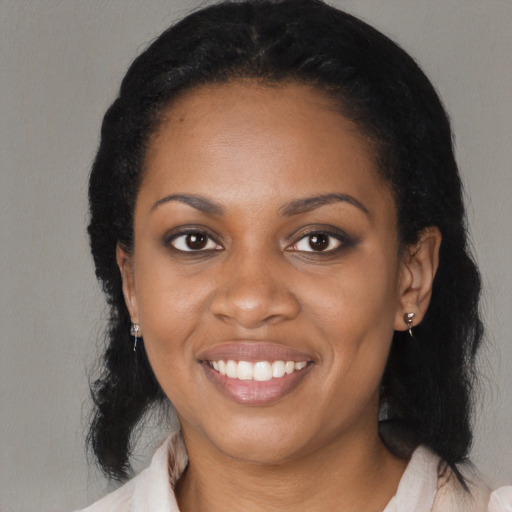 Joyful black young-adult female with medium  black hair and brown eyes