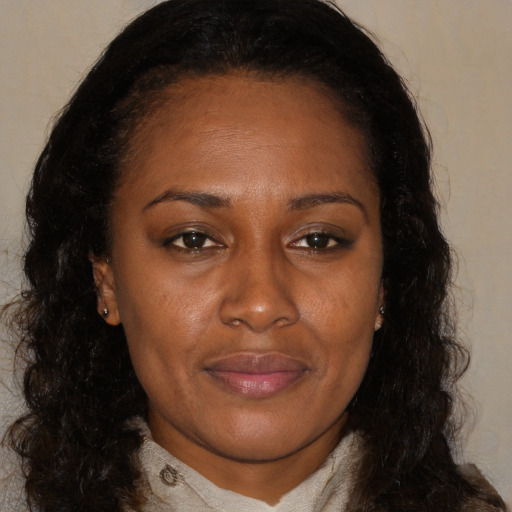 Joyful latino adult female with long  brown hair and brown eyes