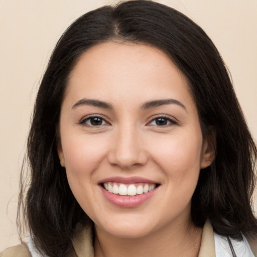 Joyful white young-adult female with long  brown hair and brown eyes