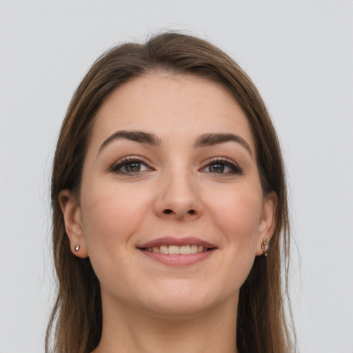 Joyful white young-adult female with long  brown hair and grey eyes