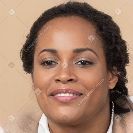 Joyful black young-adult female with long  brown hair and brown eyes